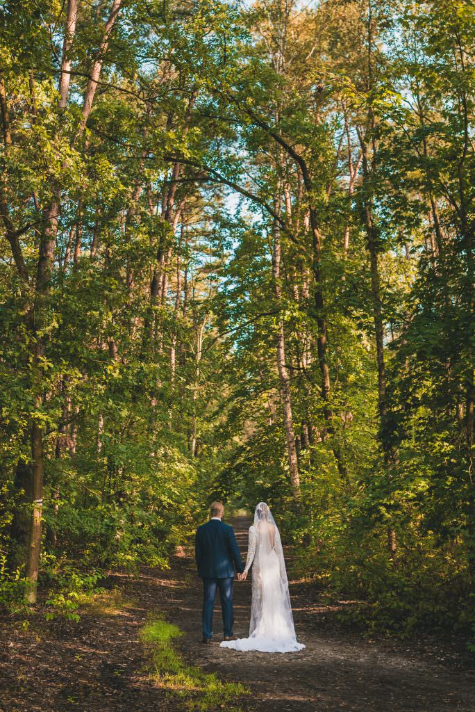 groom and bride in the forest back