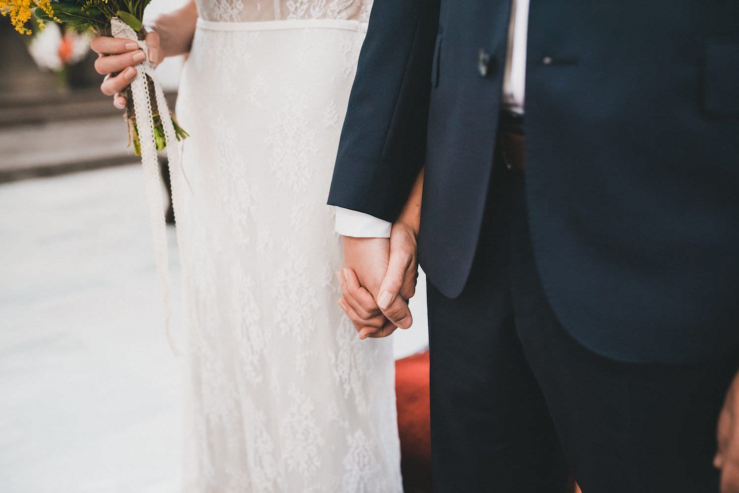 wedding groom and bride holding their hands
