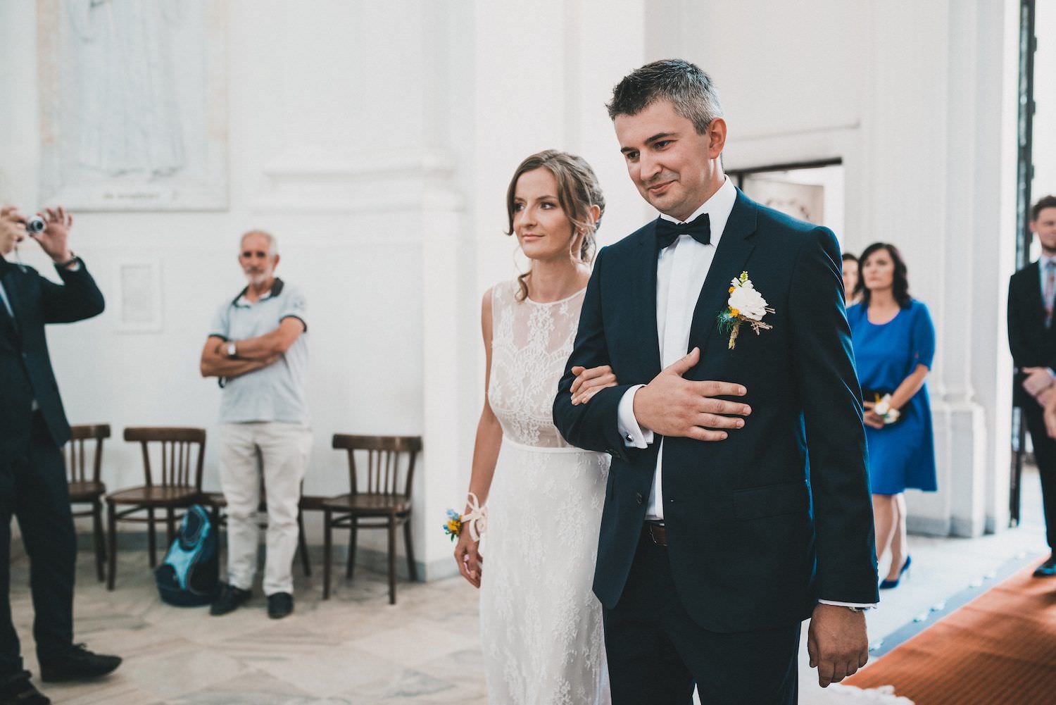 the groom leads the bride to the altar church Poland