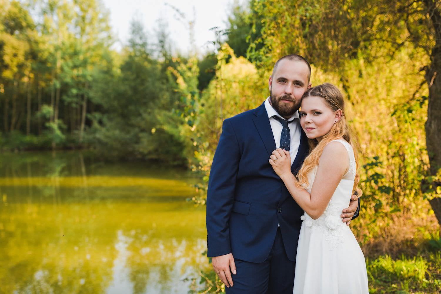 married couple with the lake