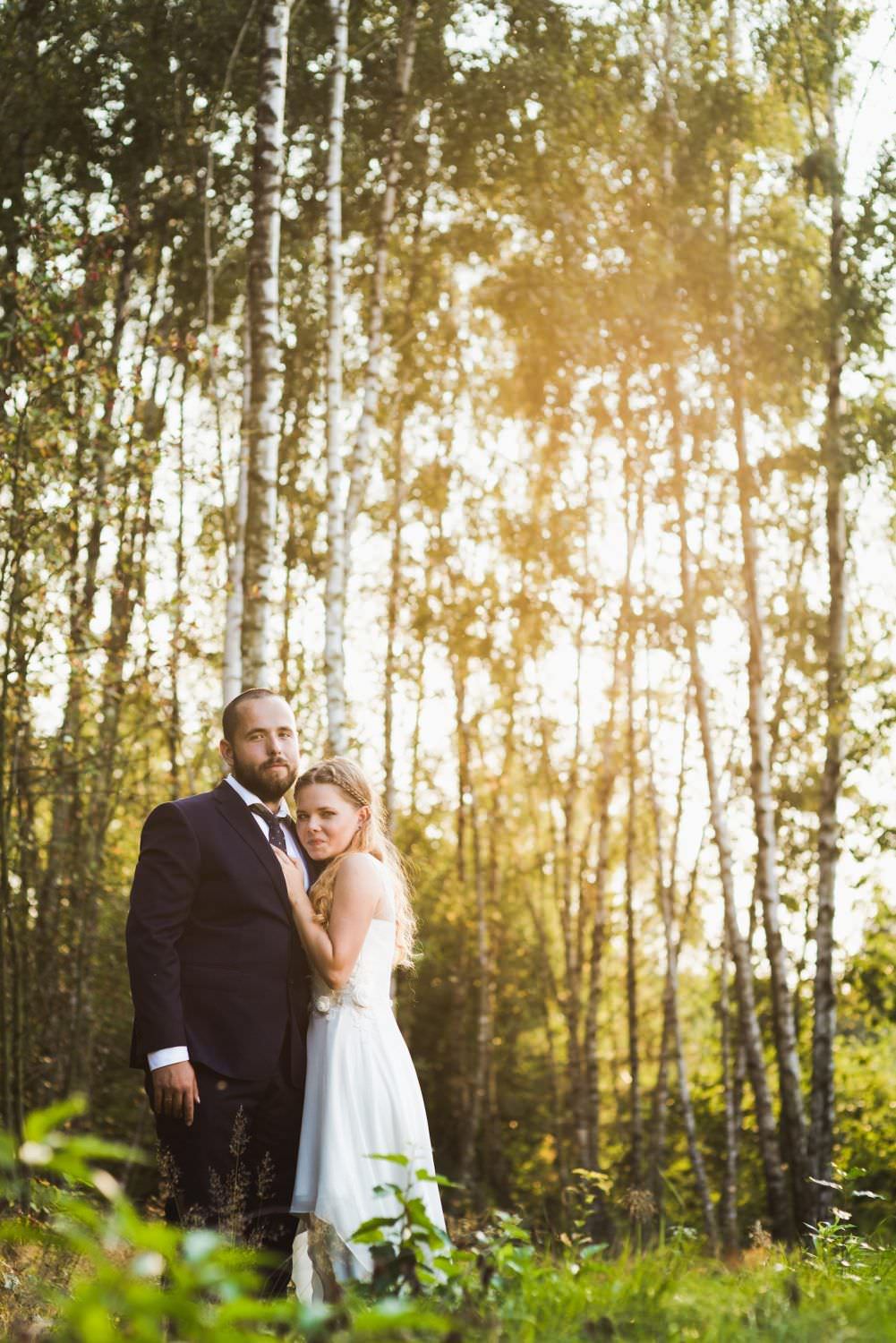 married couple in the forest and sun