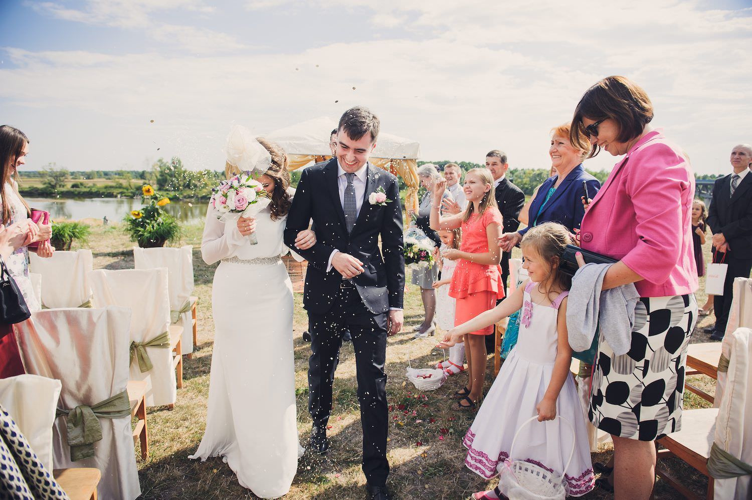 groom bride kids throwing flowers in the air wedding ceremony open air brok town