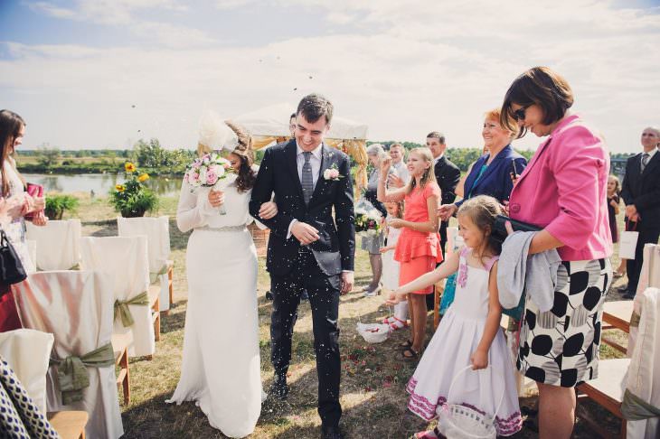 groom bride kids throwing flowers in the air wedding ceremony open air brok town