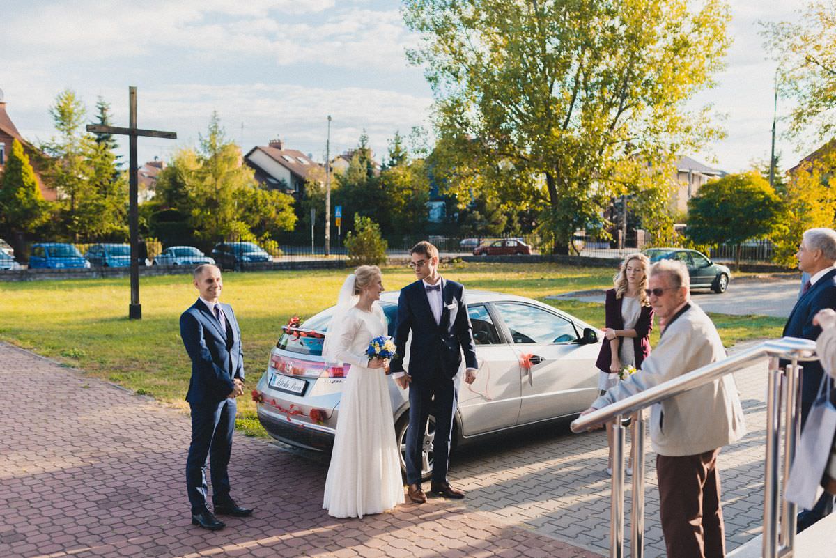 bride and groom in front of the church