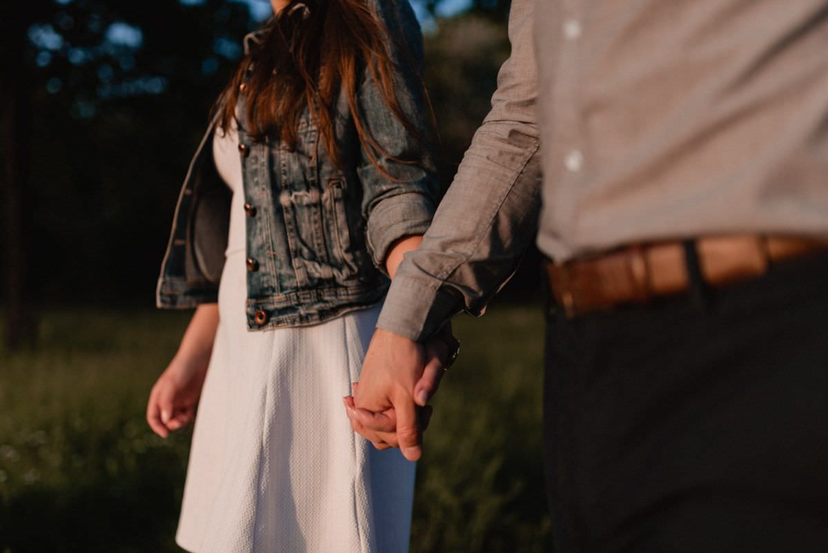 lovers are walking holding hands close-up on the palms