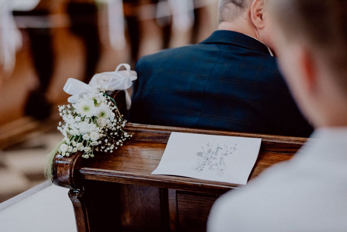 white card with songs in the church on the bench