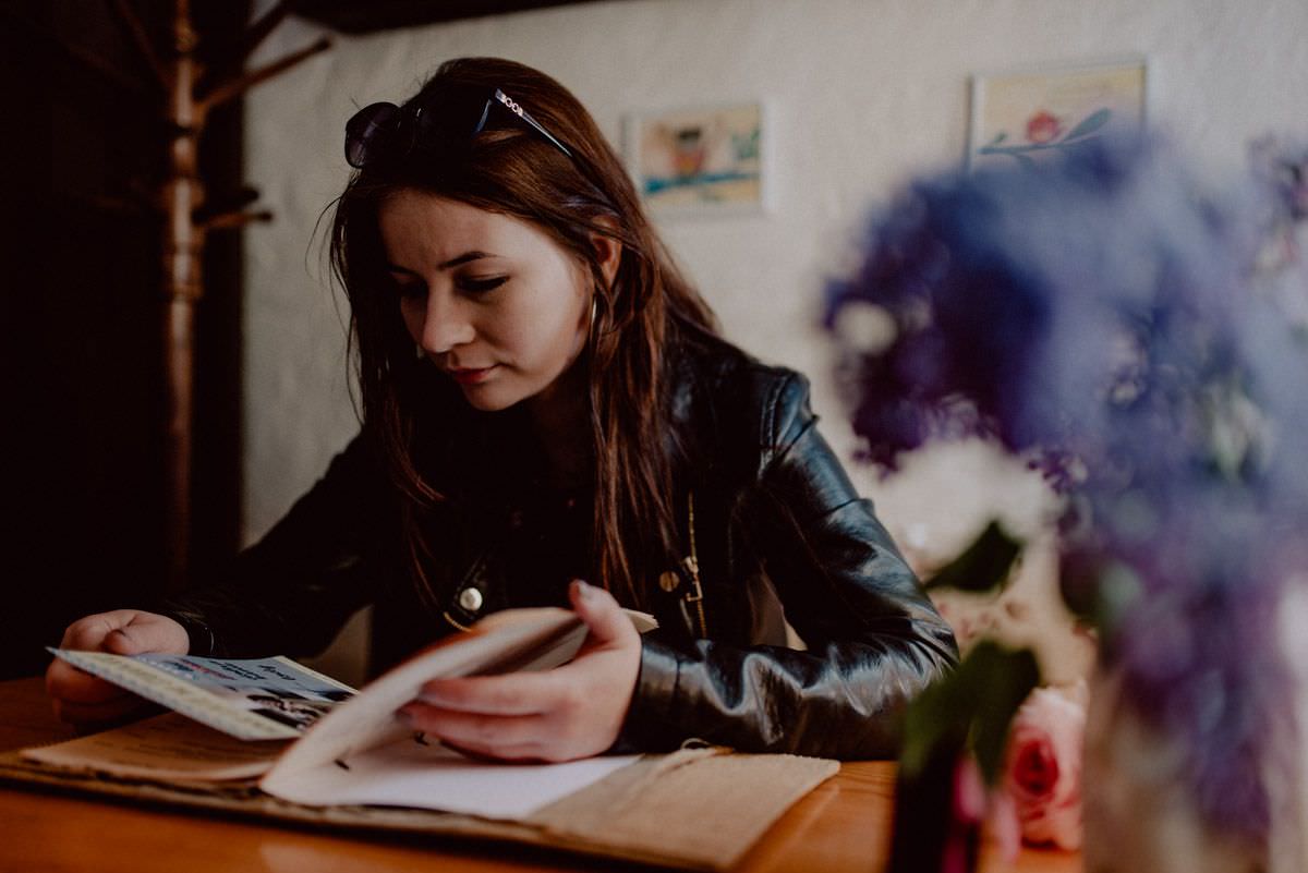 girl in a cafe reading menu