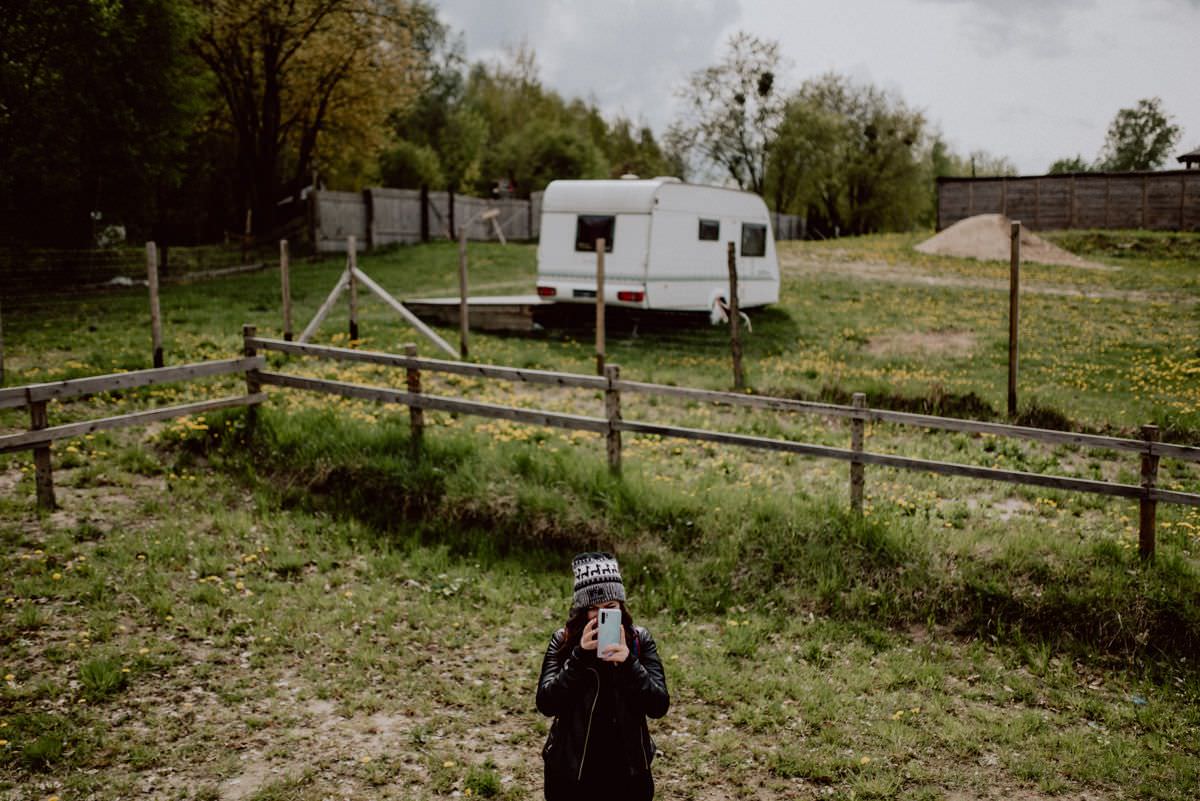 girl and camper in background