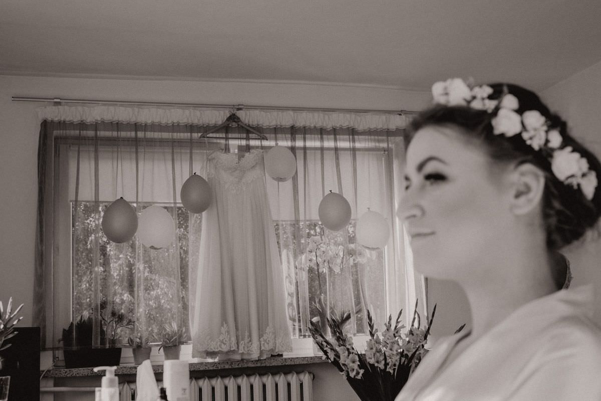 bride and wedding dress in the window