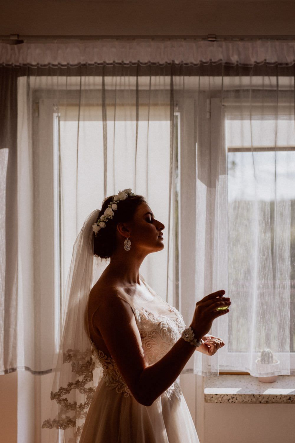the bride is spraying perfume