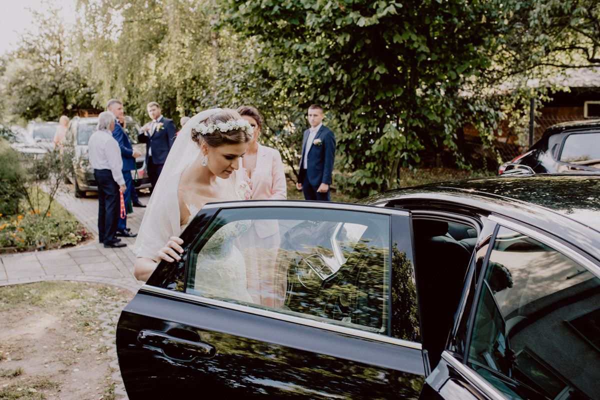 bride goes into the black car