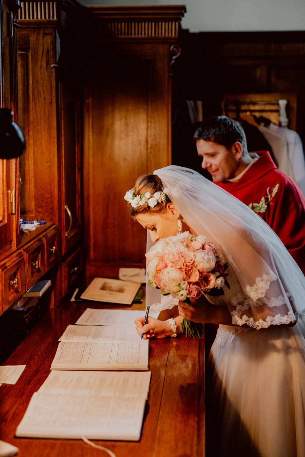 bride signs the church documents