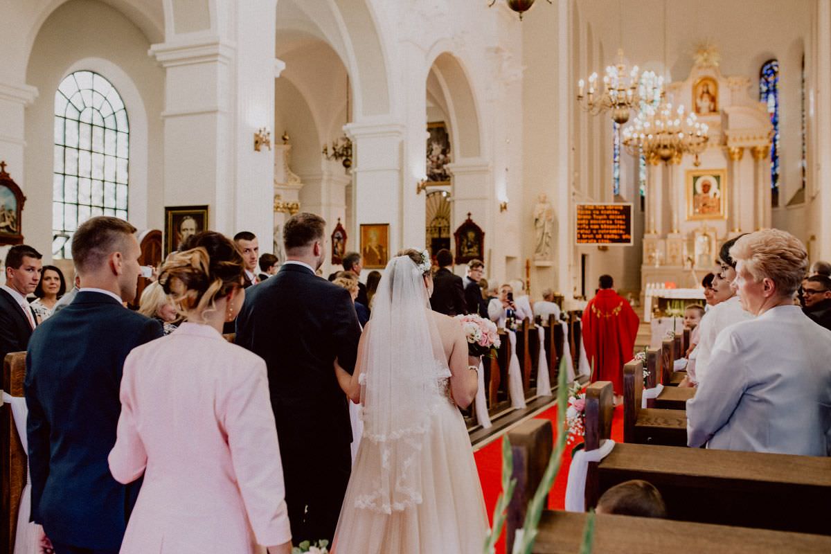 bride and groom goes into the church and smiling