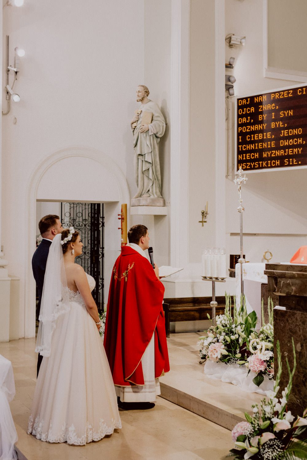 bride and groom in front of the altar