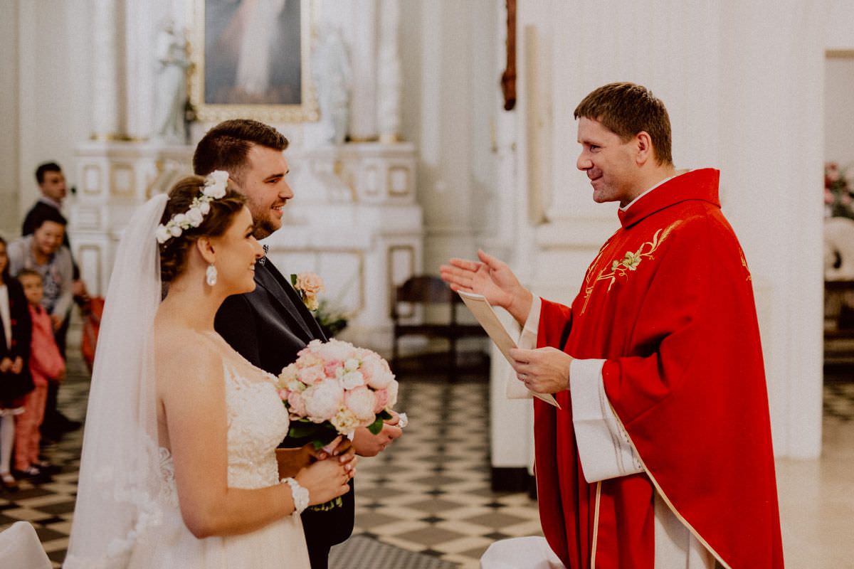 married couple and priest in the church