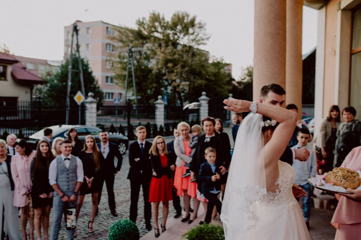 the groom and the bride throw glasses behind each other