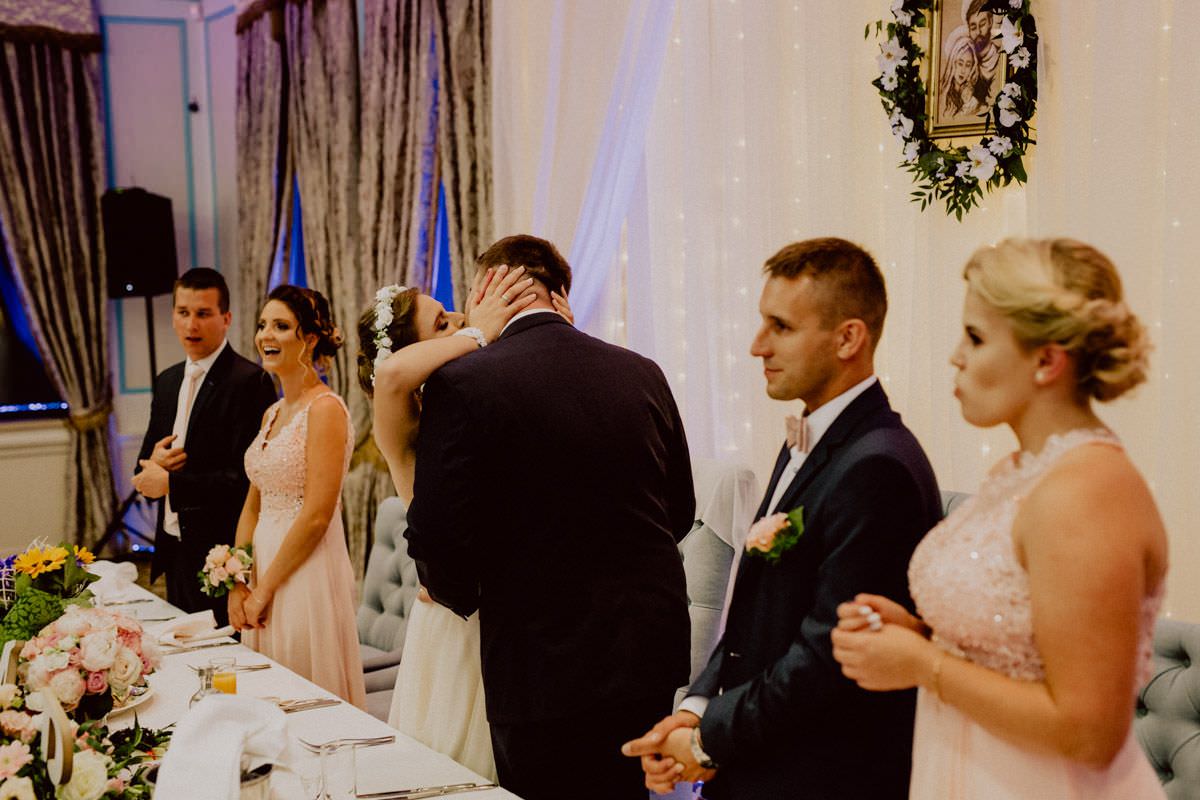 bride and groom kissing on the wedding party
