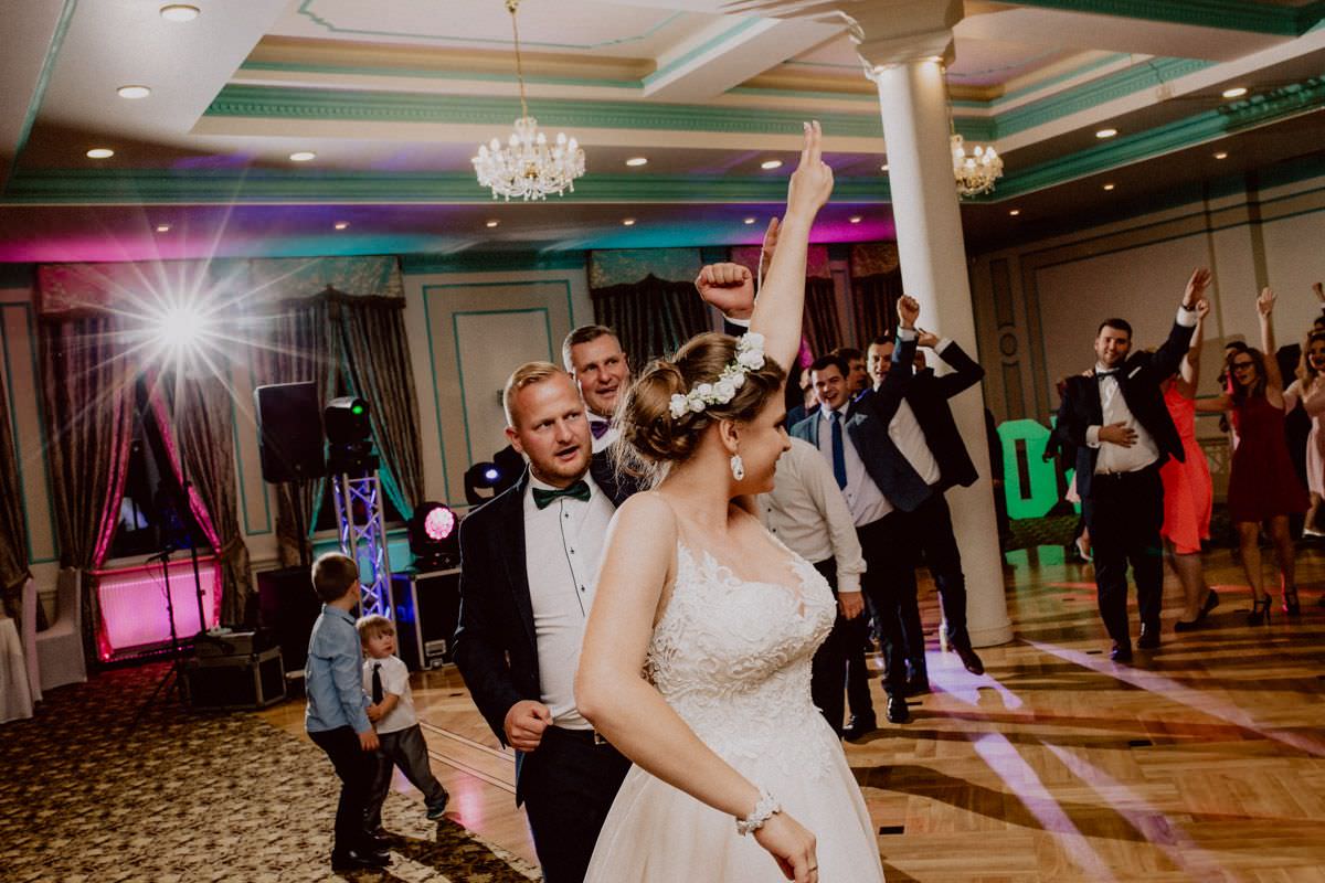 bride takes people on dance floor