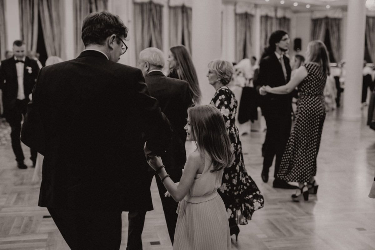 man hold daughter in hand on wedding party