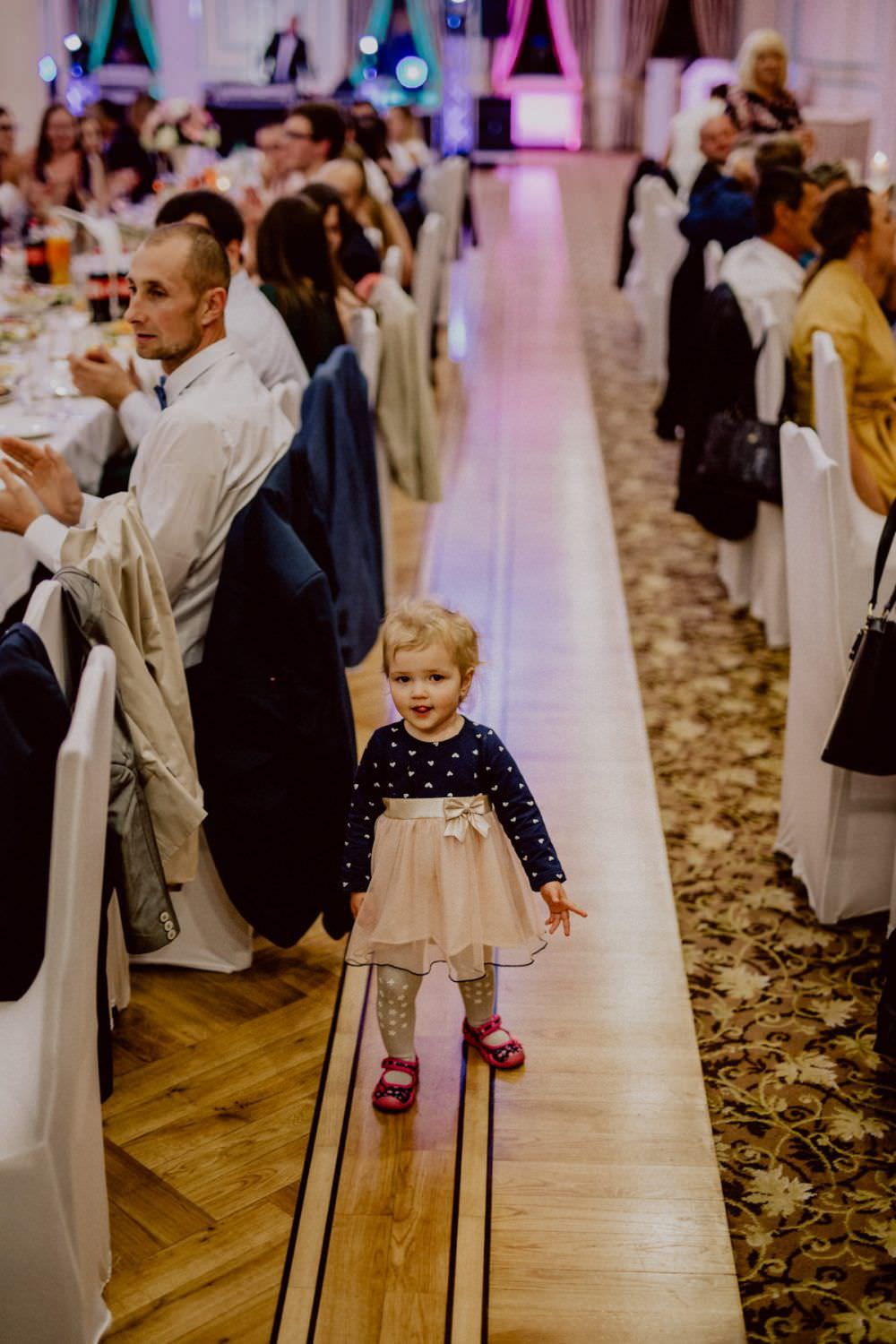 little girl between tables on wedding party