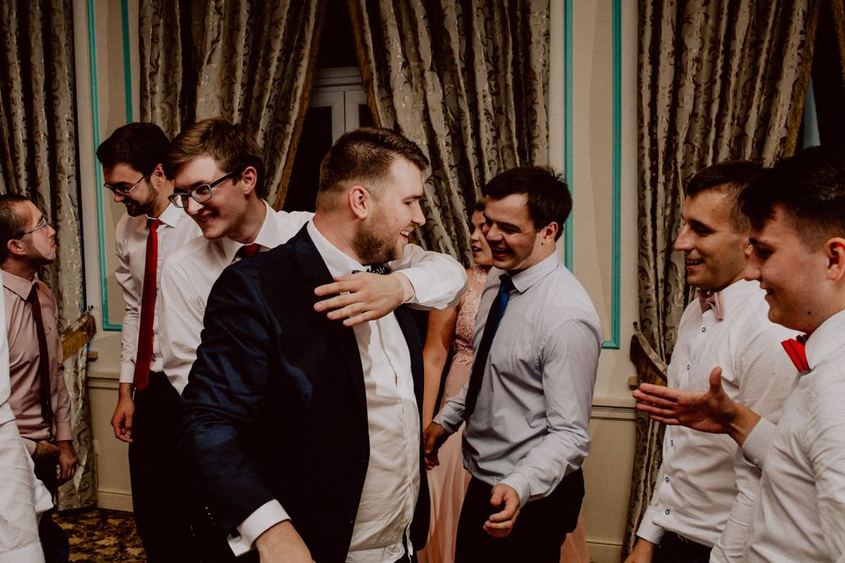 man embraces the groom