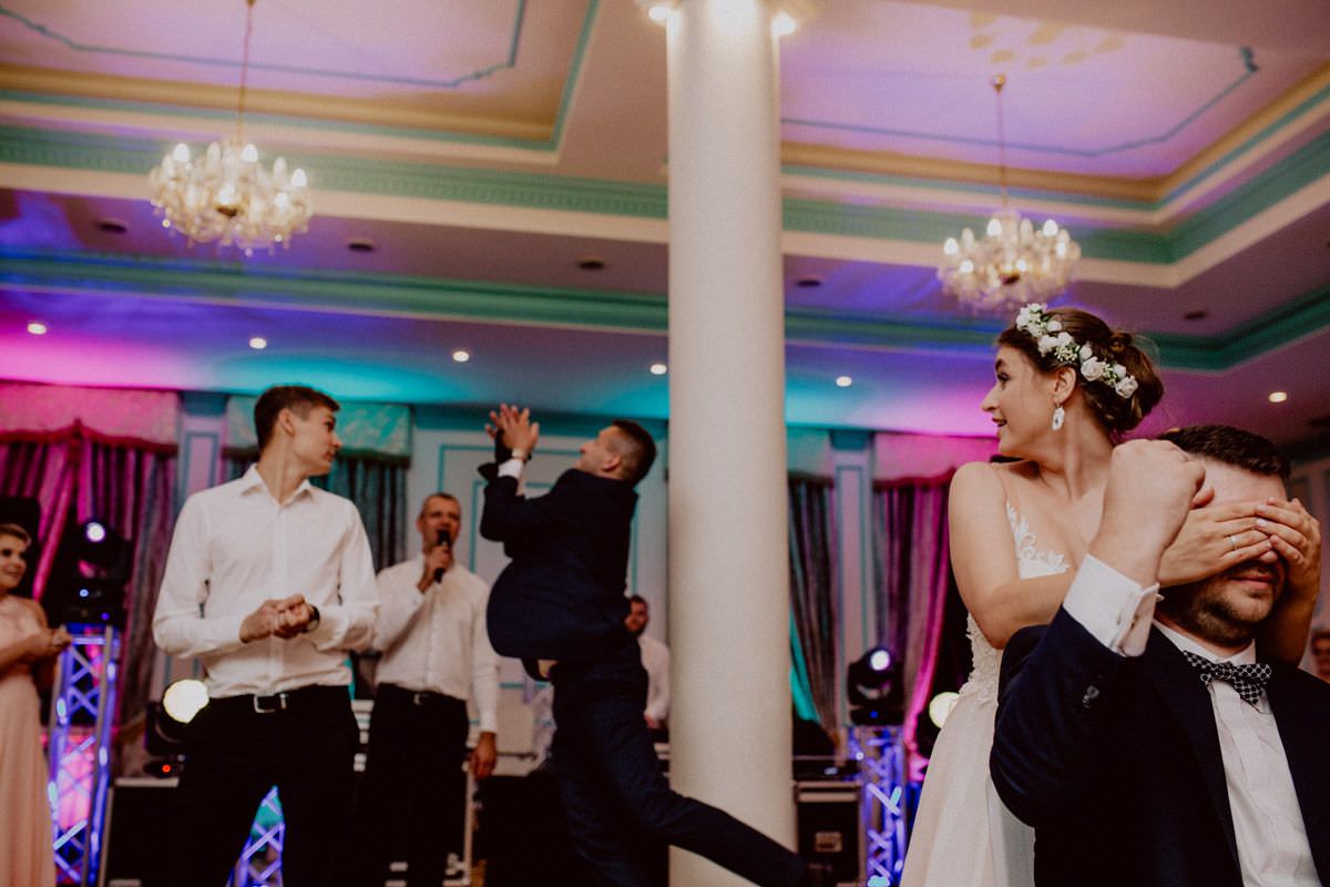 the groomsman is catching a bow tie on wedding game