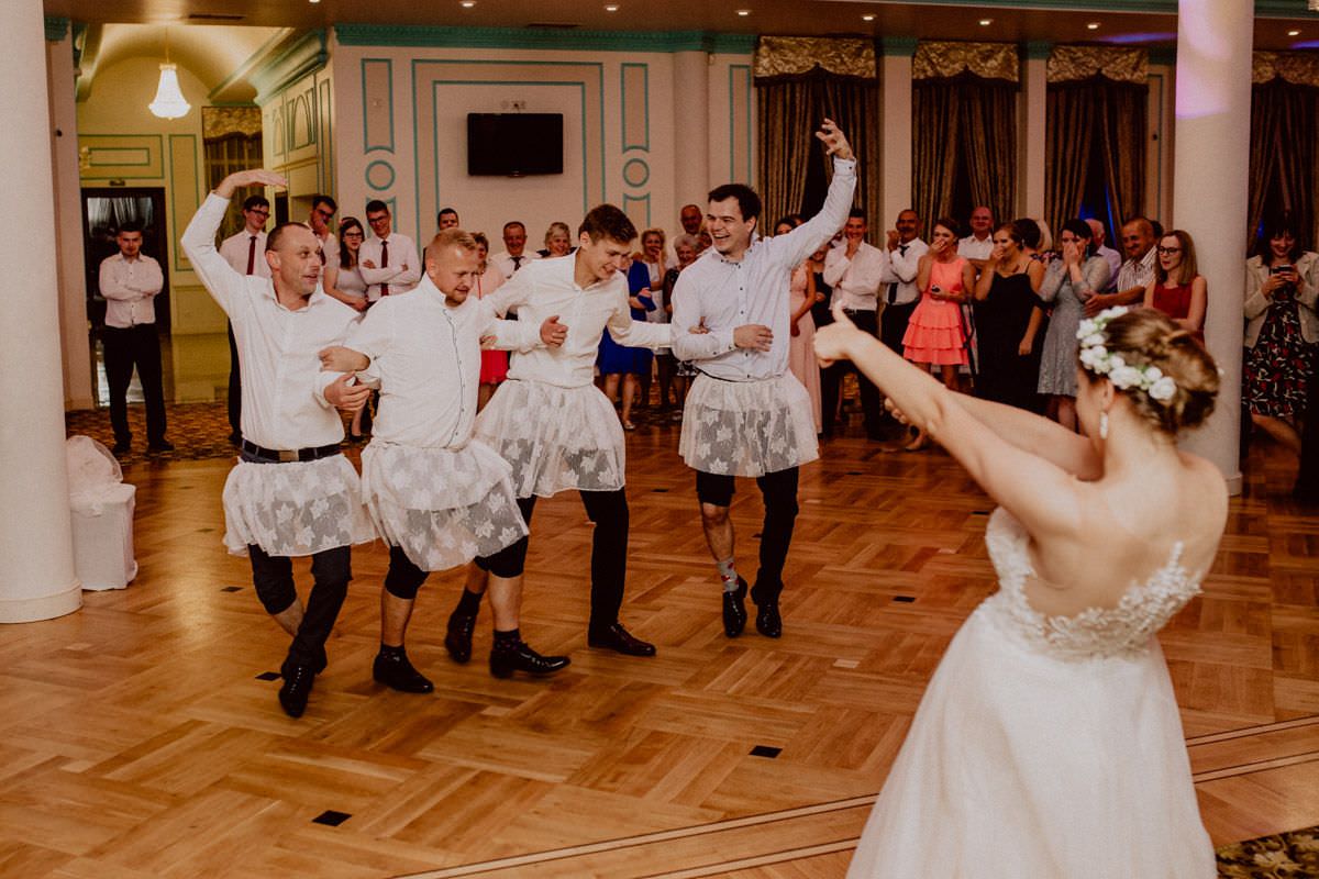 funny dressed men are dancing in front of the bride