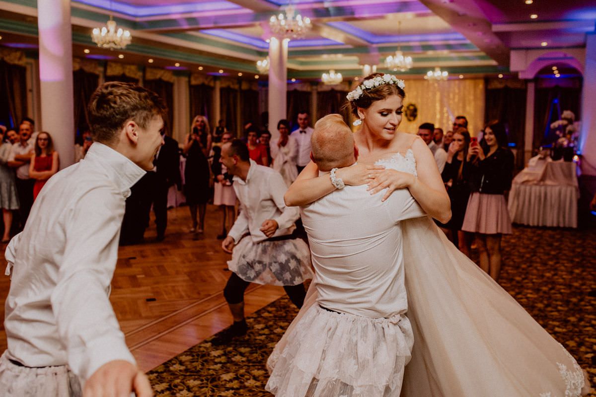 wedding guest dancing with the bride in funny skirt
